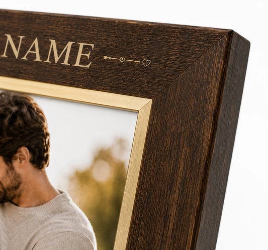 Wooden picture frame with engraved name and a photo of a person outdoors