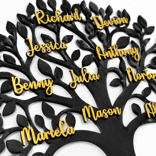 Black metal wall art family tree with gold names on wooden background