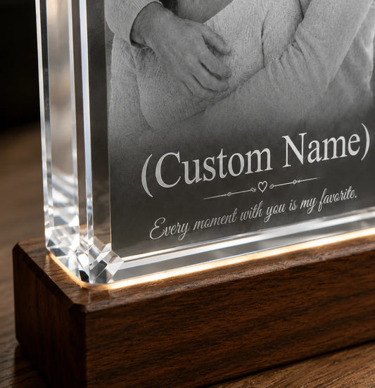 Custom engraved glass block with a photo and text on wooden base