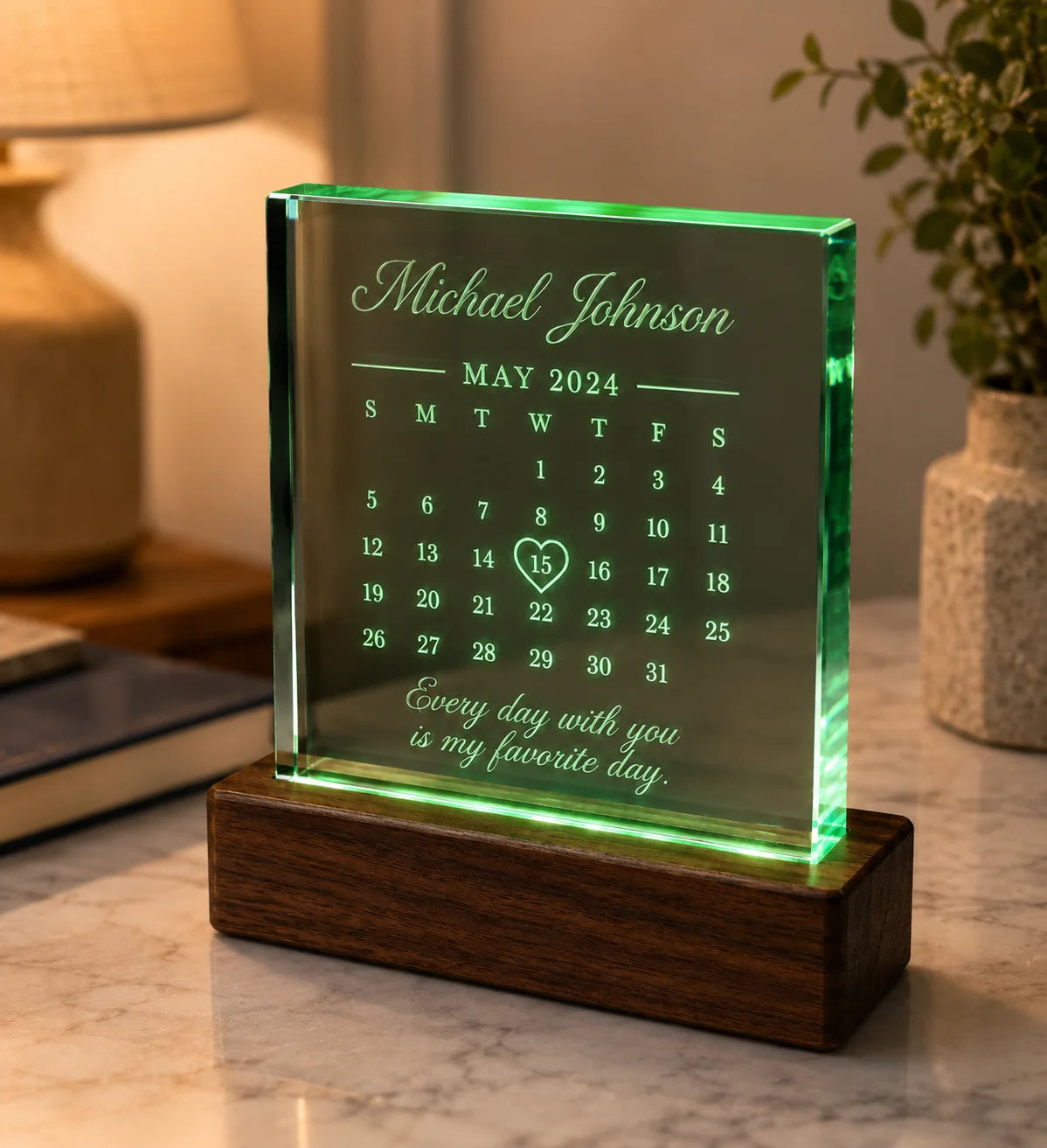 Illuminated glass memorial plaque on wood base displaying May 2024 calendar