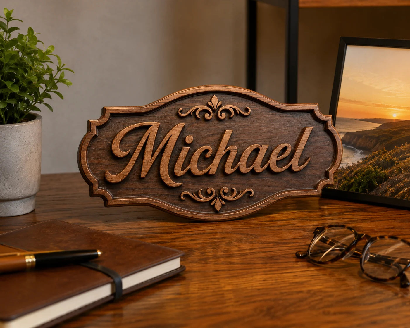 Wooden desk with Michael nameplate, potted plant, laptop, notebook, and glasses