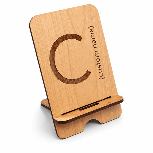 Customizable wooden phone stand with engraved letter and text on light wood